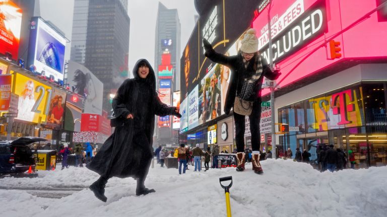 Snow in NYC: Photos from winter 2016-2017 44 Visitors frolic on a snowbank as snow and sleet fall on Times Square in Manhattan on Tuesday, March 14, 2017.