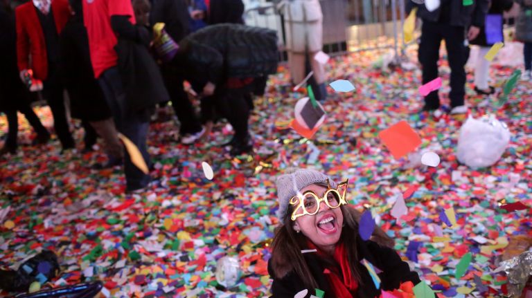 New Year's Eve Times Square ball drop: See photos 28 A woman rolls around in confetti in Times Square just after midnight on Sunday, Jan. 01, 2017.