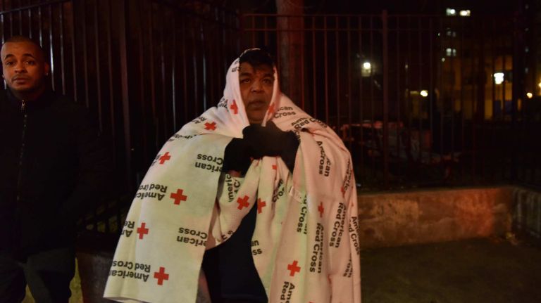 Fire in Belmont, Bronx: Photos from the scene 11 Evacuated residents try to keep warm with Red Cross blankets at the scene of a huge blaze in the Belmont neighborhood of the Bronx on Thursday, Dec. 28, 2017.