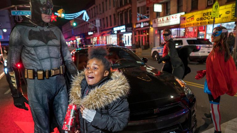 Aniah Jeffries, 9, of Brooklyn, is pretty excited after meeting some superheroes (or, NYPD officers) on Dec. 21, 2017.
