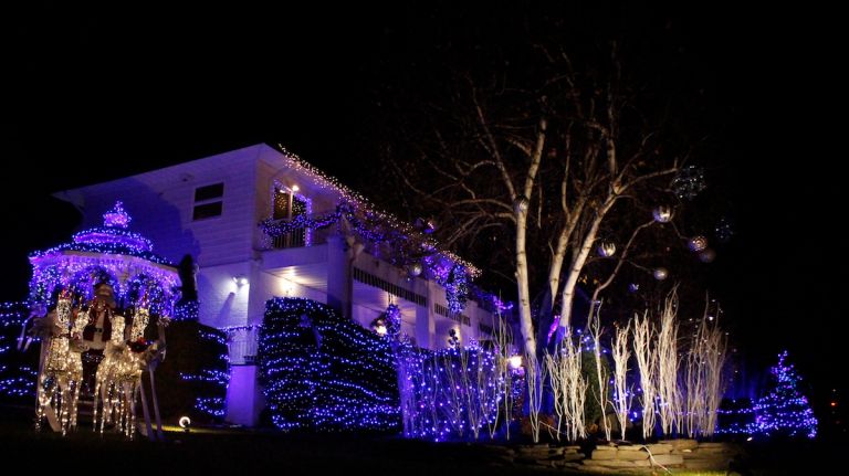 Dyker Heights Christmas lights photos: Best and brightest holiday decorations 10 Santa and his reindeer will feel perfectly at home on this property. Decorated in mainly blue and white lights, the display casts a chilly aura that goes hand-in-hand with the December wind, but nevertheless succeeds in warming visitors' hearts.