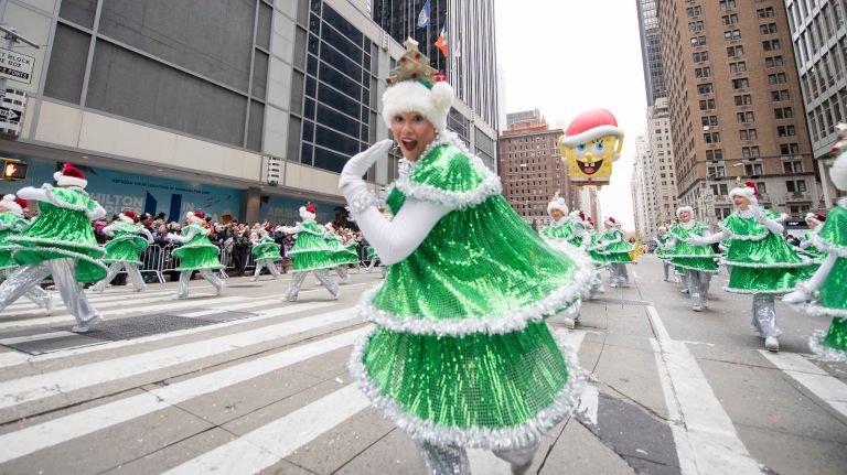 Performers dressed as Christmas trees tap dance down Sixth Avenue on Thursday, November 24, 2016, during the 90th Macy's Thanksgiving Day Parade in Manhattan.