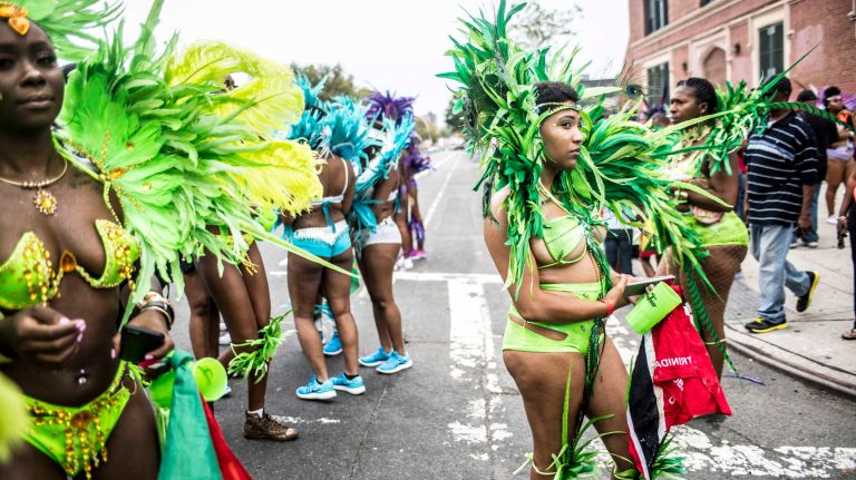 Costumed dancers get ready to march in the West Indian Day Parade along Eastern Parkway in Brooklyn on Monday, Sept. 5, 2016.