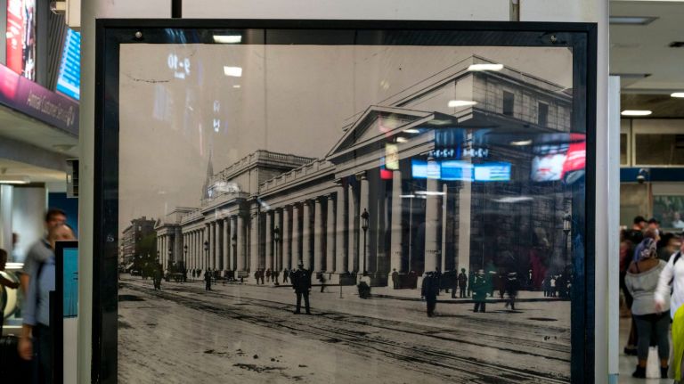 Penn Station's history is hidden in plain sight 12 The color and light of modern signage is reflected in an image of the original Penn Station that graces a column in the Amtrak waiting area at Penn Station in Manhattan, Tuesday, Aug. 8, 2017.