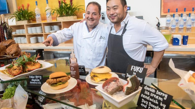 Chef David Chang (pictured right) brought his Fuku fare to the U.S. Open for the first time in 2016. Along with his popular Fuku chicken sandwich (bottom left), he is serving up a new 163 Burger (bottom center) being touted as a U.S. Open exclusive - two LaFrieda beef patties topped with cheese, lettuce and special sauce atop a unique bun by the nonprofit Hot Bread Kitchen. HBK's bing bun is an interpretation of a baked snack food popular in Taiwan. 