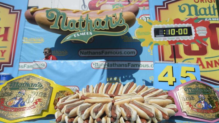 The champion belts and a platter of hot dogs are displayed during Nathan's Famous Fourth of July International Hot Dog Eating Contest in Coney Island, Brooklyn, on Monday, July 4, 2016. This year marks the 100th anniversary of the annual Fourth of July hot dog eating contest.