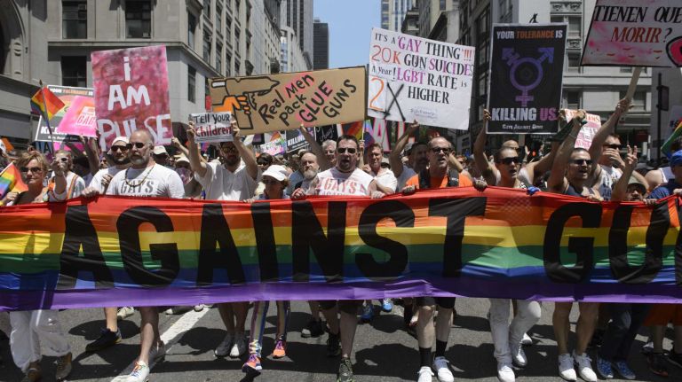 NYC Pride March 2016: See photos of the annual march to commemorate the Stonewall riots 104 Participants march with signs saying
