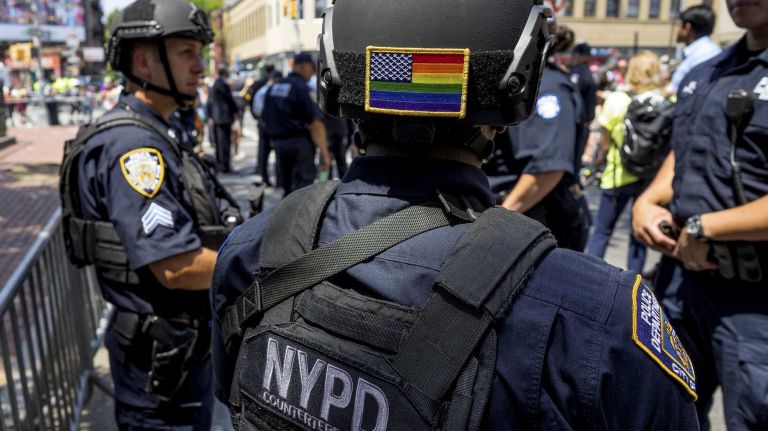NYC Pride March 2016: See photos of the annual march to commemorate the Stonewall riots 146 An NYPD officer wearing a rainbow flag stands by for the Pride March to pass by near The Stonewall Inn in West Village on Sunday, June 26, 2016. The March, the highlight of NYC Pride week, is estimated to draw over a million viewers and supporters to the streets this year as the LGBT community and others come together in solidarity in the wake of the massacre at Pulse nightclub in Orlando.