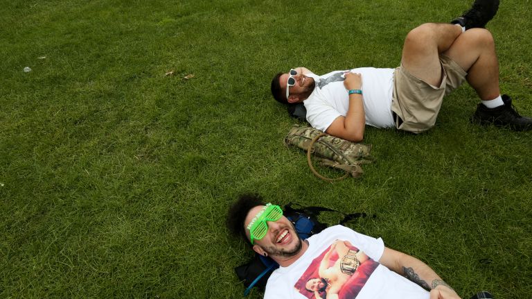 Ricardo Arteca, left, and Logan Bonilla, both from Astoria, relax on the lawn Sunday at the Governors Ball on Randall's Island.