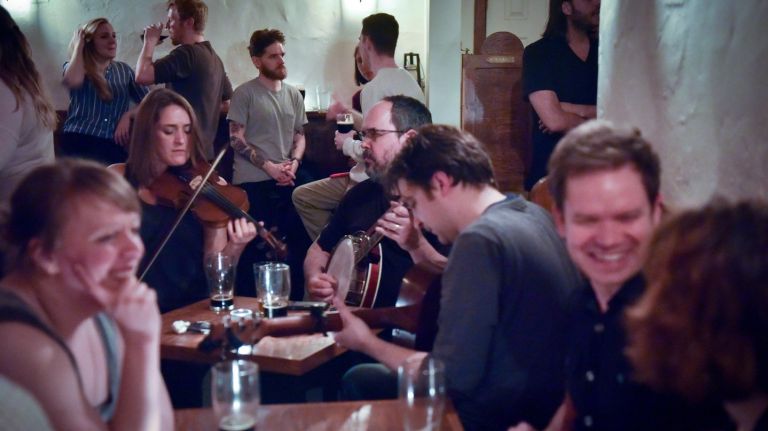 From left, Katie Fischer on fiddle, Dan Neely on the tenor banjo and Matt Stapleton on guitar during a recent Irish music session at Hartley's in Clinton Hill.