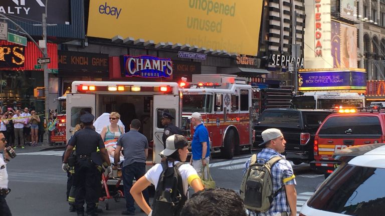 An injured pedestrian, one of 23 people who were struck by a car in Times Square, is taken to an ambulance on May 18, 2017.