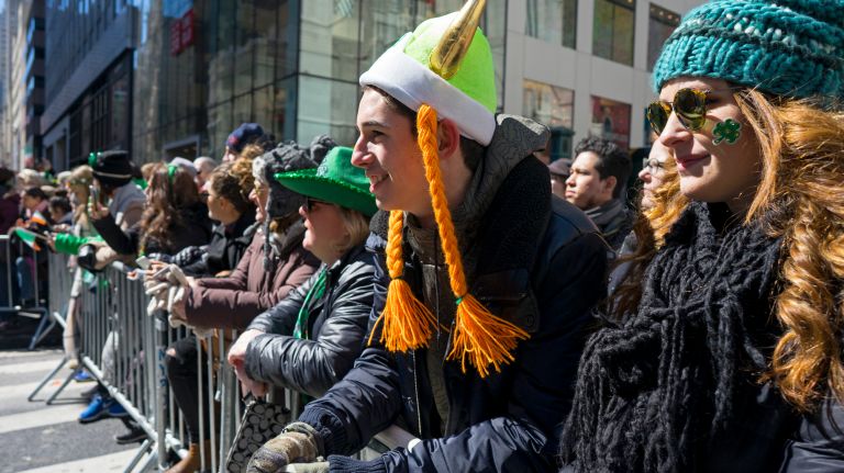 Spectators watch the New York City St. Patrick's Day parade Friday, March 17, 2017, in Manhattan.
