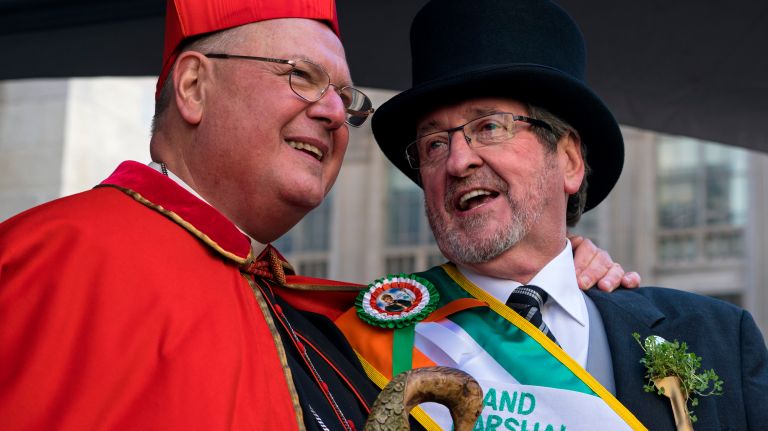 Cardinal Timothy Dolan, left, stands in front of St. Patrick's Cathedral with parade Grand Marshall Michael J. Dowling during the New York City St. Patrick's Day parade Friday, March 17, 2017, in Manhattan.