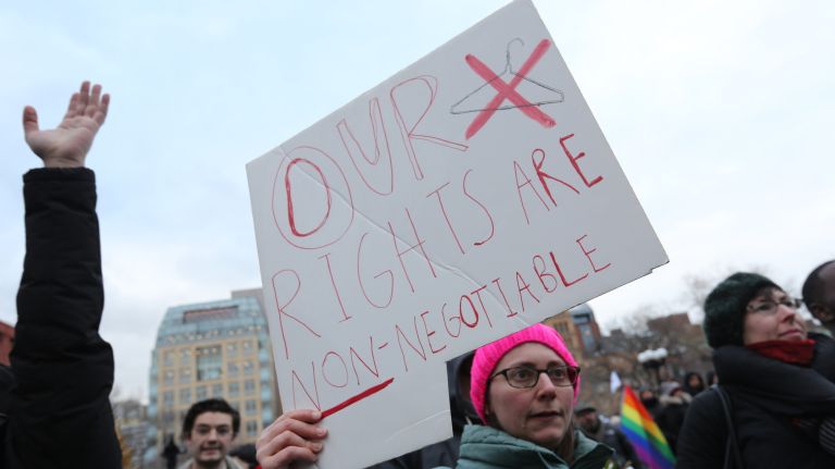 A woman holds a sign during the International Women's Strike and rally in Washington Square Park, coinciding with International Women's Day, on Thursday, Mar. 8, 2018.