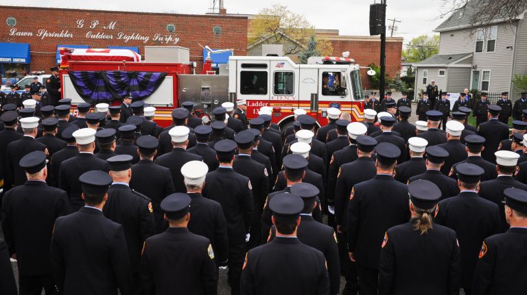 Firefighters salute as the funeral procession for FDNY firefighter William Tolley makes its way to St. Martin of Tours Roman Catholic Church in Bethpage, Thursday, April 27, 2017.