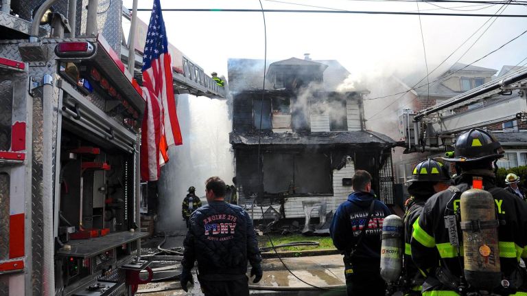 FDNY firefighters work at a house fire at 112th Avenue and 208th Street in Queens Village on Sunday, April 23, 2017.