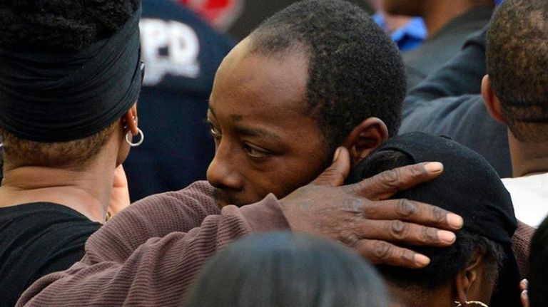 People comfort each other after the fatal house fire in Queens Village on Sunday, April 23, 2017.
