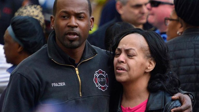 People react after the fire in Queens Village on Sunday, April 23, 2017.