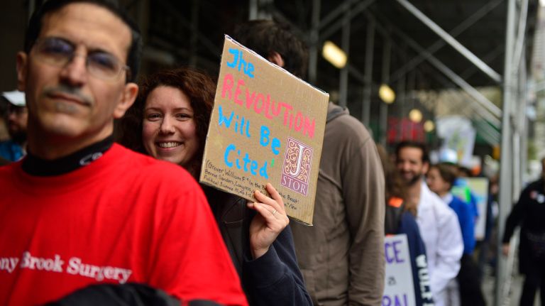 March for Science in NYC: Photos of the Earth Day rally against Trump 23 A woman smiles from behind her sign on Saturday, April 22, 2017, during the March for Science in Manhattan.