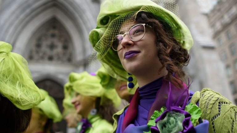 Brightly dressed people gather on Fifth Avenue for the Easter parade and bonnet festival.
