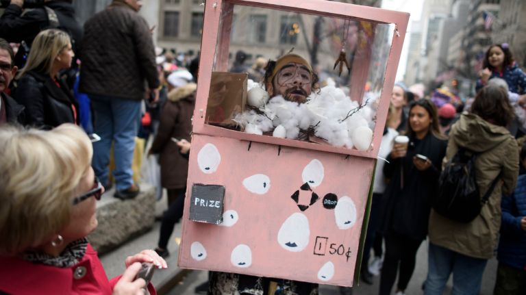 A man is dressed as a claw machine on Fifth Avenue.
