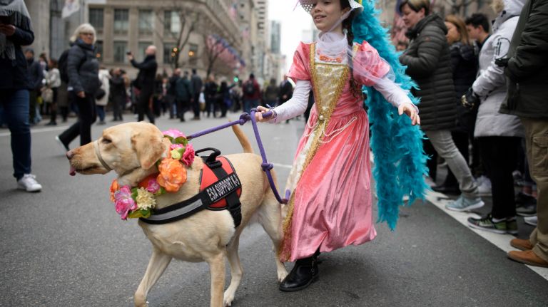 A girl and her dog celebrate Easter on Fifth Avenue.