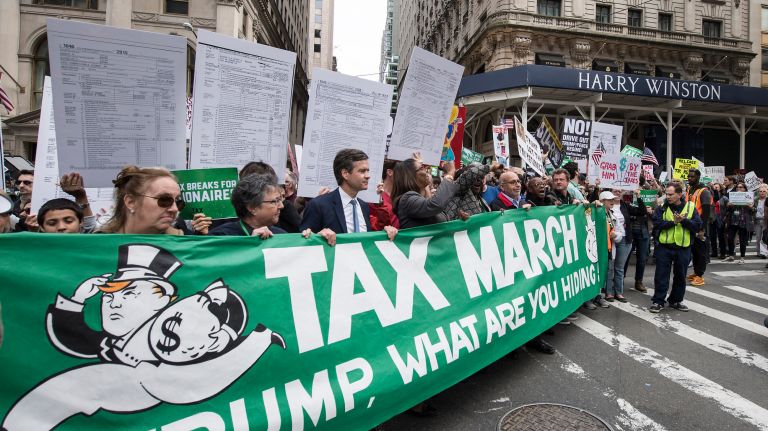 Thousands of protesters gather outside Bryant Park on Saturday, April 15, 2017, calling on President Donald Trump to release his tax returns. 