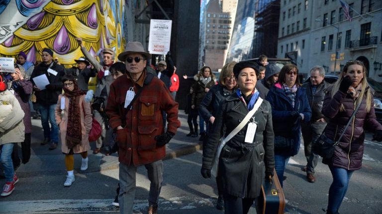 Karen Lee, the lead organizer of a Silent Peace March and about two dozen others head to the Japanese American Church on 7th Ave. in Manhattan on Saturday, Feb. 18, 2017. 75 years ago, President Franklin D. Roosevelt signed executive order 9066 in 1942, which authorized the U.S. military to remove 120,000 people of Japanese descent, from their homes on the west coast to inland concentration camps. Most were U.S. citizens at the time of their internment. To commemorate the day and to show solidarity with Muslim Americans who fear being banned from the U.S., dozens of people walked to the Japanese American Church where they were met by internment survivors.