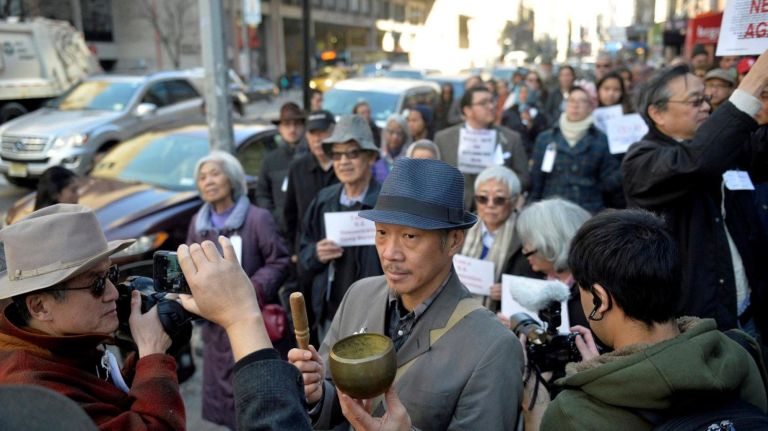 Perry Yung (52) rings a Buddhist bell near the Japanese American Church in Manhattan on Saturday, Feb. 18, 2017. About two dozen people walked from Columbus Circle to the Japanese American Church on 7th Ave. to commemorate the Japanese Americans who were held in concentration camps on U.S. soil 75 years ago after President Franklin D. Roosevelt signed executive order 9066 in 1942. The executive order authorized the U.S. military to remove 120,000 people of Japanese descent from their homes on the west coast to inland concentration camps. Most were U.S. citizens at the time of their internment. The marchers were met by a handful of internment survivors as they neared the church. The march was a show of solidarity with Muslim Americans who fear the next executive order could potentially ban them from the U.S.