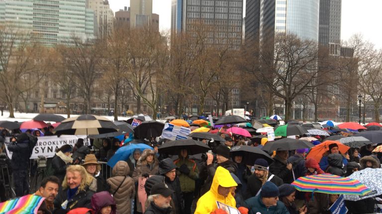Protesters braved the rain and gathered in Battery Park to attend a rally in support of refugees on Feb. 12, 2017. 