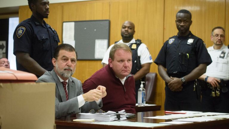 Daniel Steininger, center, is arraigned in New York State Supreme Court in Manhattan, Wednesday, Feb. 21, 2018. Steininger and more than a dozen individuals are charged with widespread fraud in the towing industry.