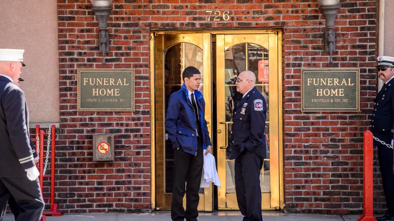 A family member, left. speaks with an EMT at the wake for Yadira Arroyo at the Joseph A. Lucchese Funeral Home on Morris Park Avenue in the Bronx, Thursday, March 23, 2017.