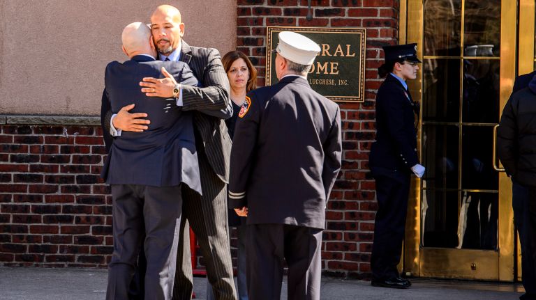 Salvatore Cassano, left, former FDNY Commissioner, and Bronx Borough President Ruben Diaz Jr. embrace outside the wake for Yadira Arroyo at the Joseph A. Lucchese Funeral Home on Morris Park Avenue in the Bronx, Thursday, March 23, 2017.