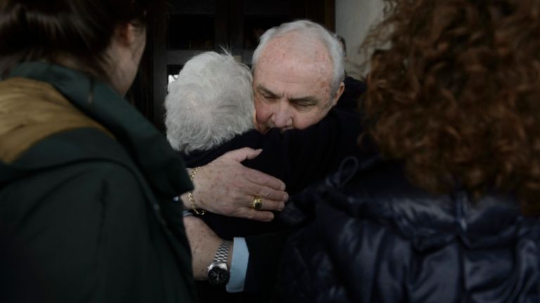 Ronnie Eldridge, center, the widow of Pulitzer Prize-winning columnist Jimmy Breslin, hugs former NYPD Det. Bill Clark, who befriended her husband during the Son of Sam case, before the start of her husband's funeral Mass at the Church of the Blessed Sacrament in Manhattan on Wednesday, March 22, 2017.