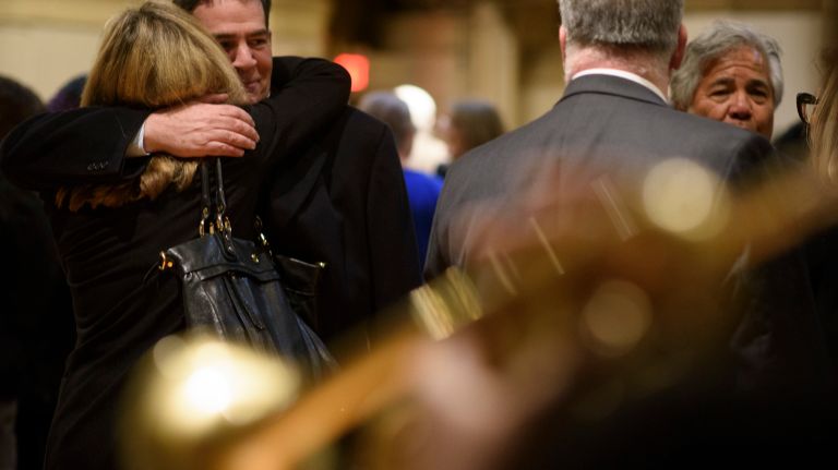 Patrick Breslin, the son of Pulitzer Prize-winning columnist Jimmy Breslin, hugs a fellow mourner during a gathering after his father's funeral Mass at the Church of the Blessed Sacrament in Manhattan on Wednesday, March 22, 2017. 