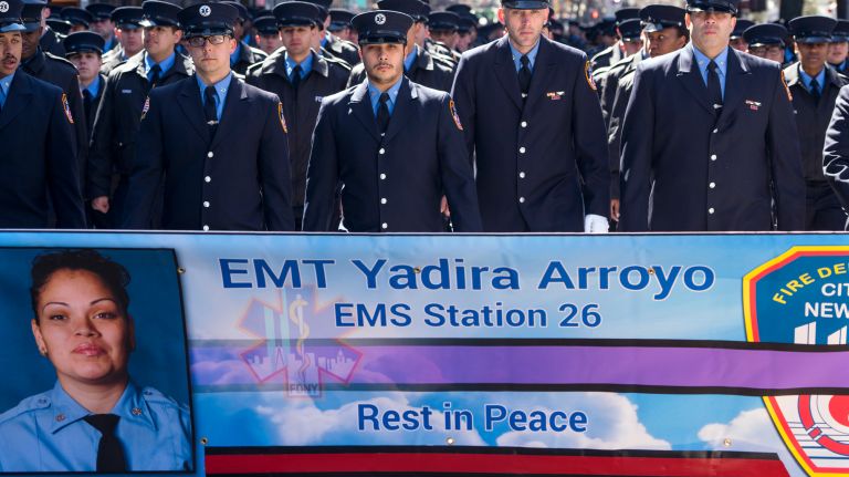 FDNY members walk behind a banner displaying an image of Yadira Arroyo during the New York City St. Patrick's Day Parade Friday, March 17, 2017, in Manhattan. Arroyo was killed Thursday when Jose Gonzalez, 25, commandeered her ambulance and then ran her over.
