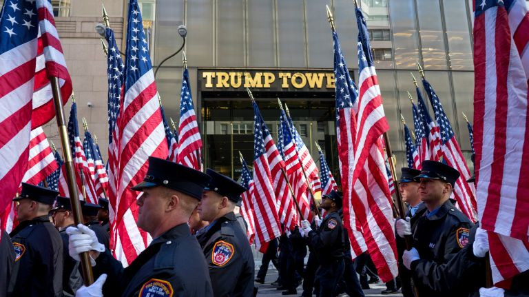 An FDNY honor guard, carrying 343 flags representing those lost during the 2001 attack on the World Trade Center, walk past Trump Tower as they march during the New York City St. Patrick's Day Parade Friday, March 17, 2017, in Manhattan.