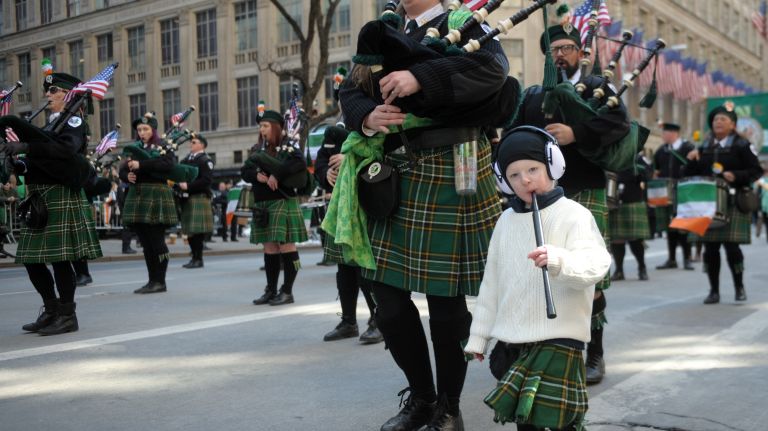 Piper Amelia Mabe marches with her daughter Angus and on her back son Alister during the St. Patrick's Day Parade on Fifth Avenue in Manhattan Friday, March 17, 2017.