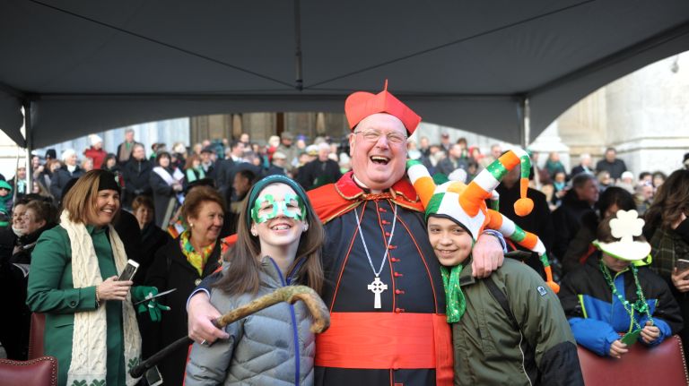 Cardinal Timothy Dolan with his niece Kathleen Dolan, left, and nephew Emmett Dolan, right, enjoy the St. Patrick's Day parade on Fifth Avenue in Manhattan Friday, March 17, 2017.