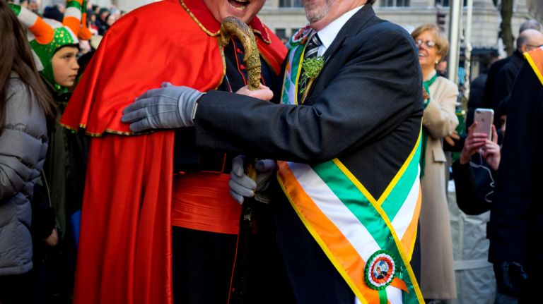 Cardinal Timothy Dolan, standing in front of St. Patrick's Cathedral, greets parade Grand Marshall Michael J. Dowling during the New York City St. Patrick's Day parade Friday, March 17, 2017, in Manhattan.