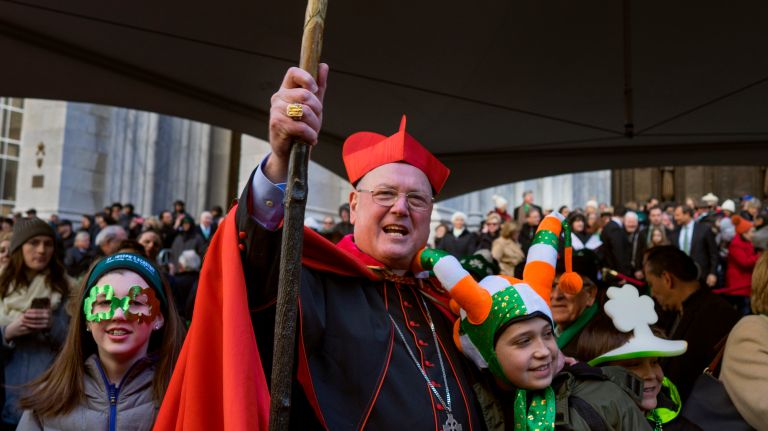 Cardinal Timothy Dolan stands in front of St. Patrick's Cathedral as he greets participants marching during the New York City St. Patrick's Day parade Friday, March 17, 2017, in Manhattan.