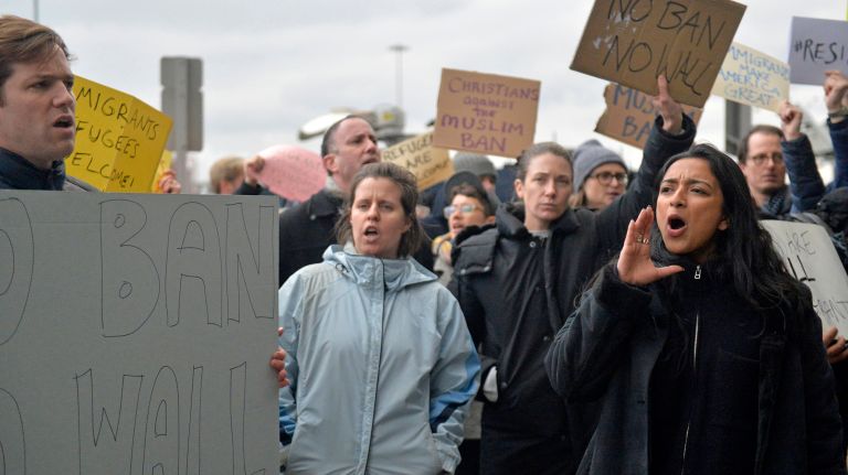 Tara Raghuveer, 24, an organizer from the National Partnership for New Americans, which is based in Chicago, leads protesters in a chant at JFK's Terminal 4 on Jan. 28, 2017.