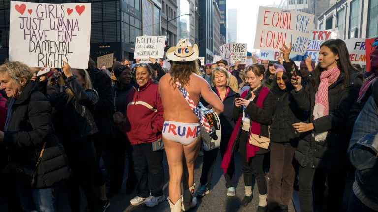 The Naked Cowboy walks through the crowd on Fifth Avenue in Manhattan on Jan. 21, 2017.