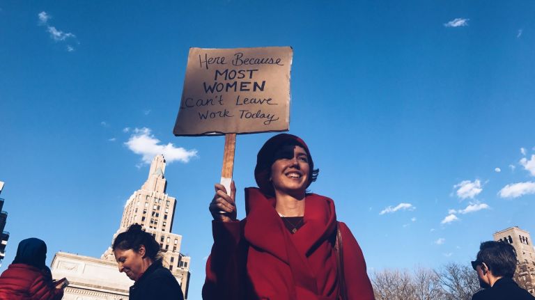 A woman holds a protest sign during the International Women's Strike rally at Manhattan's Washington Square Park on Wednesday, March 8, 2017.