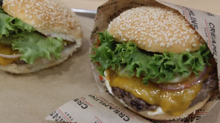 The burgers are made with grass-fed beef and topped with lettuce, onion, pickles, ketchup and mayo.