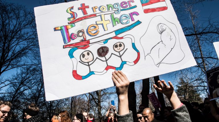 A participant holds a protest sign held during the A Day Without a Woman rally in Manhattan on International Women's Day on March 8, 2017.