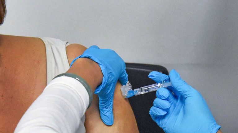 Nurse May Bernaldez gives a flu shot  to a patient at Bellevue Hospital  on Jan. 23, 2018.