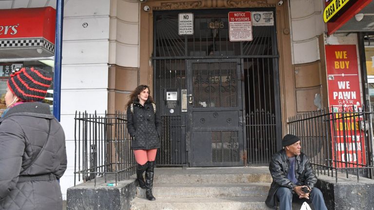 Lisa Ortega, seen outside her building, left, on Thursday, Feb. 1, 2018, and other tenants say their Bronx landlord has fail to make proper repairs for years.