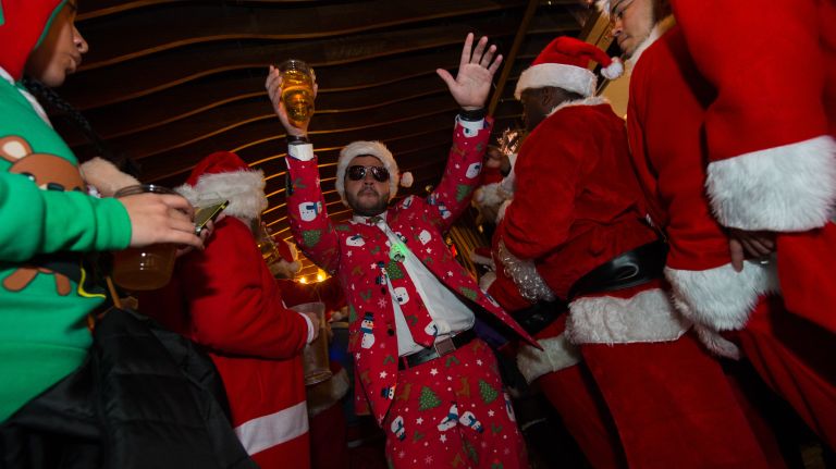 Revelers celebrate at Ainsworth Park, a bar on East 18th Street in Manhattan during SantaCon on Saturday, Dec. 10, 2016.