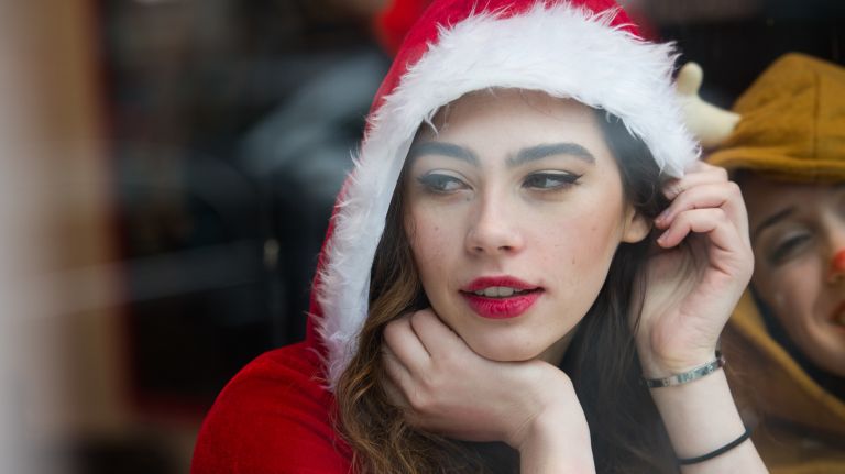 A woman dressed as Santa at Gotham Pizza on Third Avenue in Manhattan is among those participating in SantaCon on Saturday, Dec. 10, 2016.